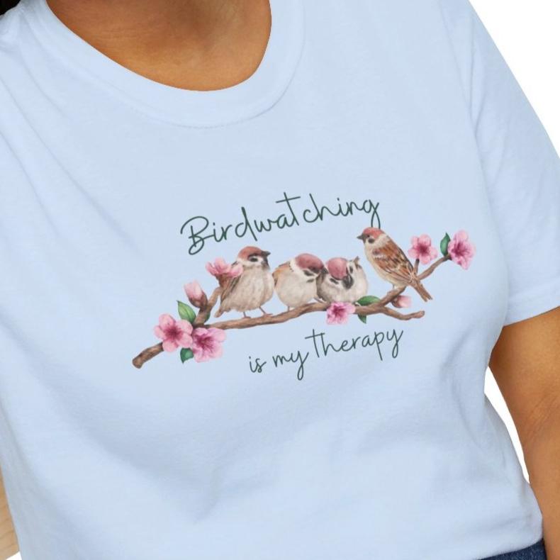 Girl wearing a nature t-shirt that says Birdwatching is my therapy