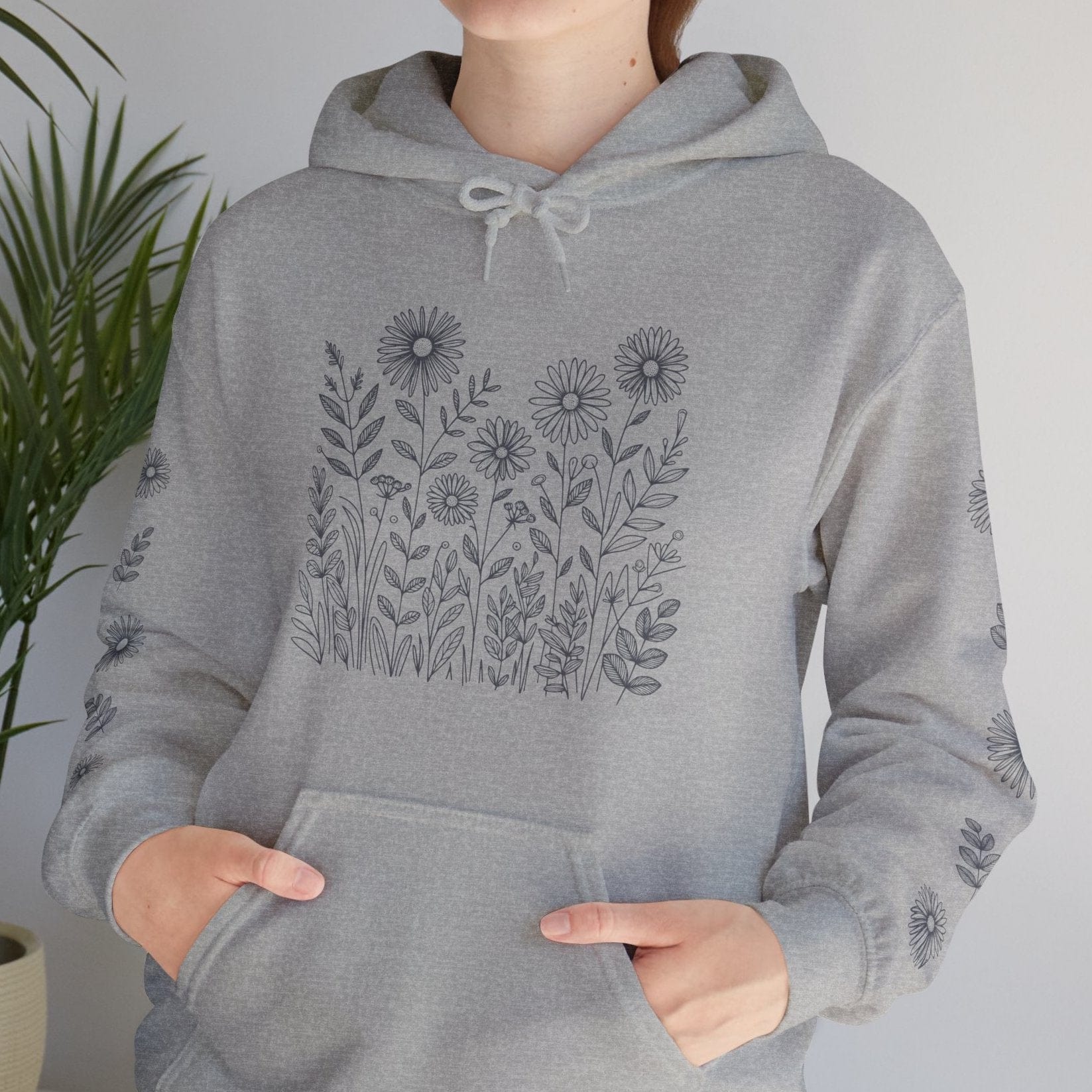 Girl wearing a Light Heather grey nature hoodie with wildflowers 