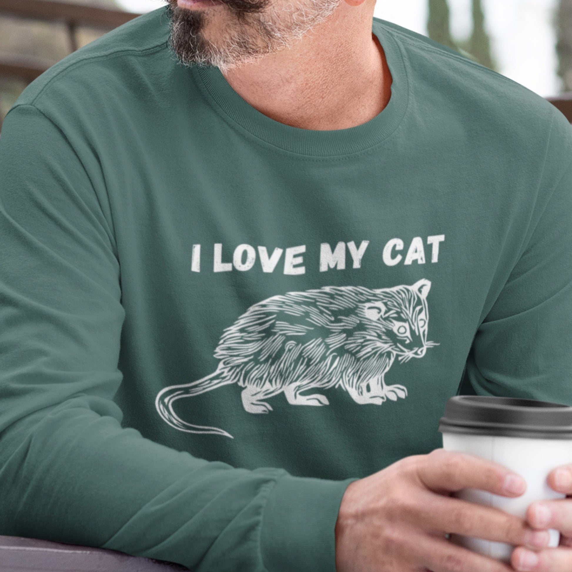 Guy wearing a funny possum t-shirt that has a drawing of an opossum and says I love my cat