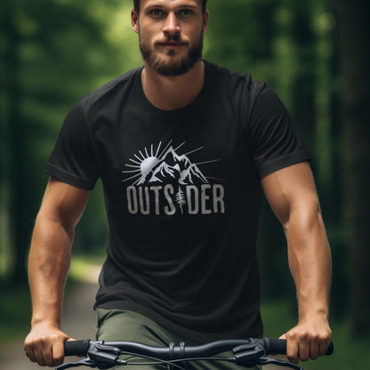 Guy riding a bike wearing a black nature t-shirt that says Outsider